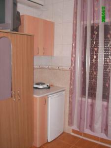 a small kitchen with a table and a window at Apartments Circle Olive in Ulcinj