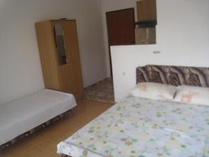 a small bedroom with a bed and a cabinet at Apartments Circle Olive in Ulcinj