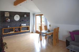 a living room with a table and a clock on a wall at Ferien bei Maria in Alfter