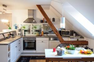 a kitchen with white cabinets and a table with fruits at SchönErleben in Schwabstedt