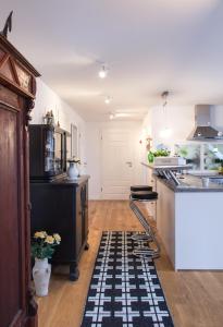 a kitchen with a black and white rug on the floor at SchönErleben in Schwabstedt