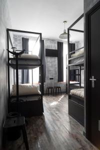 a room with two bunk beds and a table at Urban City Centre Hostel in Brussels