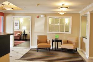 a waiting room with two chairs and a table at Extended Stay America Suites - St Louis - Westport - Central in Maryland Heights +24 photos