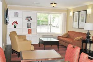 a living room with a couch and a table at Extended Stay America Suites - St Louis - Westport - Central in Maryland Heights