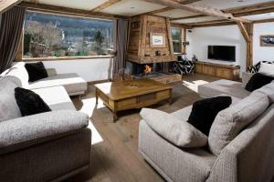 a living room with two couches and a fireplace at Chalet Martinique - Chamonix All Year in Chamonix