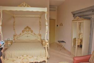 a bedroom with a white canopy bed and a cabinet at Hotel Marte in Venice