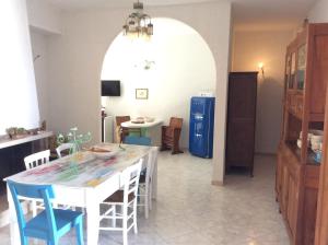 a kitchen and dining room with a table and chairs at Lisca Bianca Tropea in Tropea