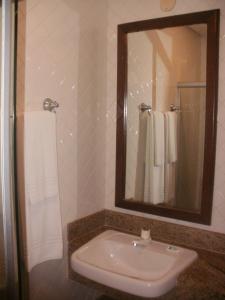 a bathroom with a sink and a mirror at Hotel Pousada Encanto de Itapoan in Salvador