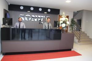 two men are standing behind a counter in a store at Sonus Hotel in Sinop