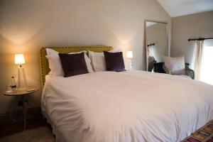 a bedroom with a large white bed with pillows at The Priory in Middleham