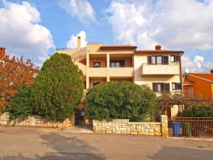 a large house with trees in front of it at Apartment Nada 1202 in Banjole
