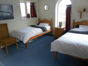 A bed or beds in a room at Country House Ashdene 