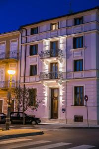 a white building on a street at night at Apartments Villa Castello in Crikvenica