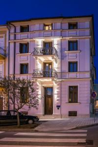 a large white building with a balcony at Apartments Villa Castello in Crikvenica