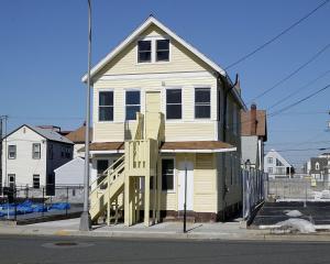 een wit huis met een veranda bij Shore Beach Houses - 38 A Lincoln Avenue in Seaside Heights