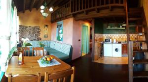 a kitchen and dining room with a table and a couch at Apartamentos Villar in Villar