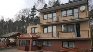 a building with balconies on the side of it at U Zenona in Stegna