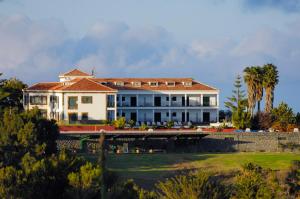 a large white house with a large yard at Bandama Golf Hotel by Airnest in Santa Brígida