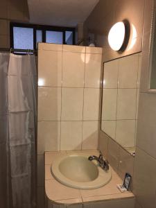 a bathroom with a sink and a mirror at Hotel Conchita in Ciudad Constitución