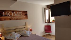 a bedroom with a bed and a flat screen tv at Casa Txema in Lorca