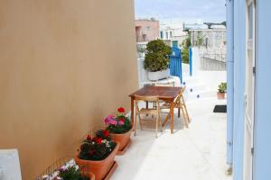 a balcony with a table and potted plants at Maridea - Via Dragonara in Ponza +11 photos
