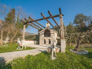 a statue of rabbits in front of a wooden structure at Apartments Ivo Bozinovic in Tivat