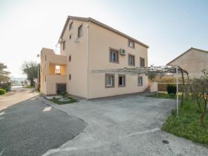 a large house with a driveway in front of it at Apartments Ivo Bozinovic in Tivat