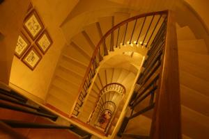 a person walking down a spiral staircase at Hotel Bremon by Grup Duquessa in Cardona
