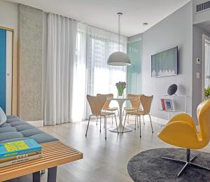 a living room with a table and chairs at ABAE Hotel by Eskape Collection in Miami Beach