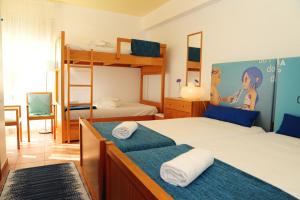 a bedroom with two beds and a bunk bed at Caparica Sun Centre in Costa da Caparica