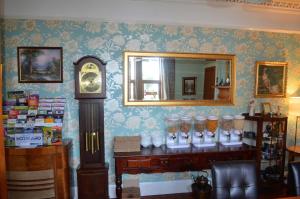 a room with a clock and a counter with a mirror at The Quaich B&B in Inverness +51 photos