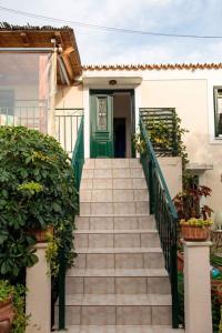 a staircase leading to a house with a green door at Toula's house 2 in Spetses