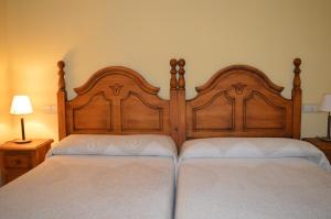 Postel nebo postele na pokoji v ubytování Hostal Revinuesa