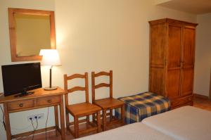 Postel nebo postele na pokoji v ubytování Hostal Revinuesa