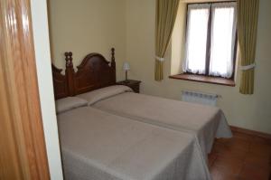 Postel nebo postele na pokoji v ubytování Hostal Revinuesa