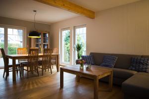 a living room with a couch and a table at H24ZINGST - Das Ferienhaus in Zingst