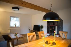 a living room with a table and a dining room at H24ZINGST - Das Ferienhaus in Zingst