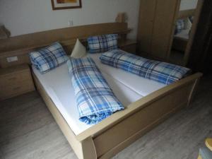 a bed with two pillows on top of it at Gasthof Alpenrose in Imsterberg