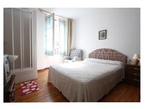 a bedroom with a bed and a window and a television at Hostal Bayón in León