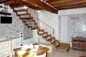 a living room with a spiral staircase in a house at House Versilia Luca E Giada, 5 chilometri da Forte dei Marmi! in Forte dei Marmi