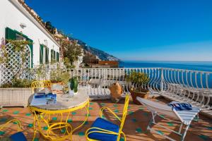 a patio with a table and chairs and the ocean at Hotel Villa Delle Palme in Positano in Positano