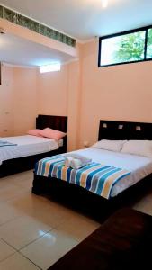 Postel nebo postele na pokoji v ubytování Hostal Duncan