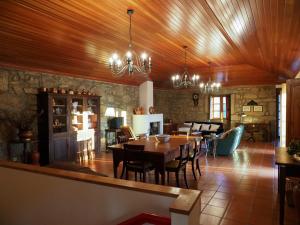 a dining room and kitchen with a table and chairs at Quinta da Pereirinha in Arcos de Valdevez