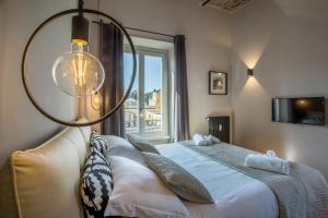 a bedroom with a bed and a large window at EVE Penthouse Colosseo in Rome