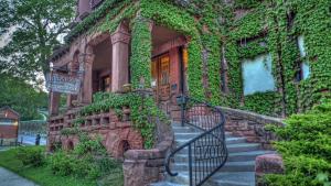 a house covered in ivy with stairs in front of it at The Redstone Inn and Suites in Dubuque