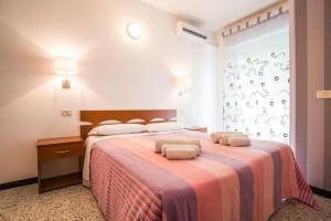 a bedroom with a large bed with two pillows on it at Hotel Hollywood in Riccione