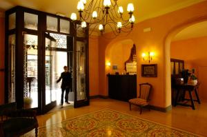 a person walking into a store with a window at Bremon Boutique Hotel by Duquessa Hotel Collection in Cardona