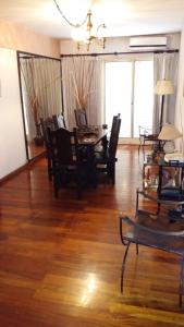 a living room with a dining room table and chairs at Mendoza 398 in Rosario