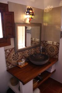 a bathroom with a sink and a mirror at Boutique Bed & Breakfast Casa Utopia in Alcaucín