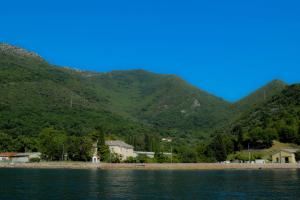 a body of water with mountains in the background at Apartments Oasis in Tivat